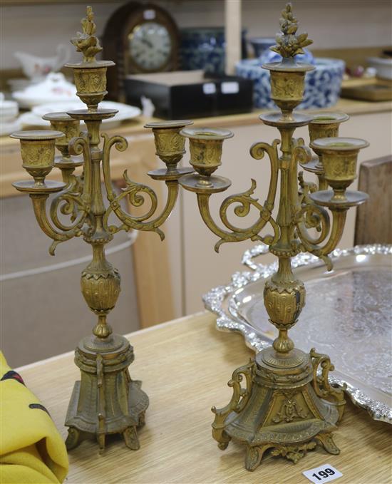 A pair of Victorian gilt metal three branch four light candelabra 40cm.